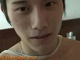 Asian twink BDSM boy gets a handjob and cum on his body.